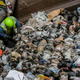 Workers sorting recyclables at a material recovery facility frequently struggle with plastic bag contamination. In this photo, bags can be seen tangling a star-wheel sorting system, preventing the proper separation of various materials.